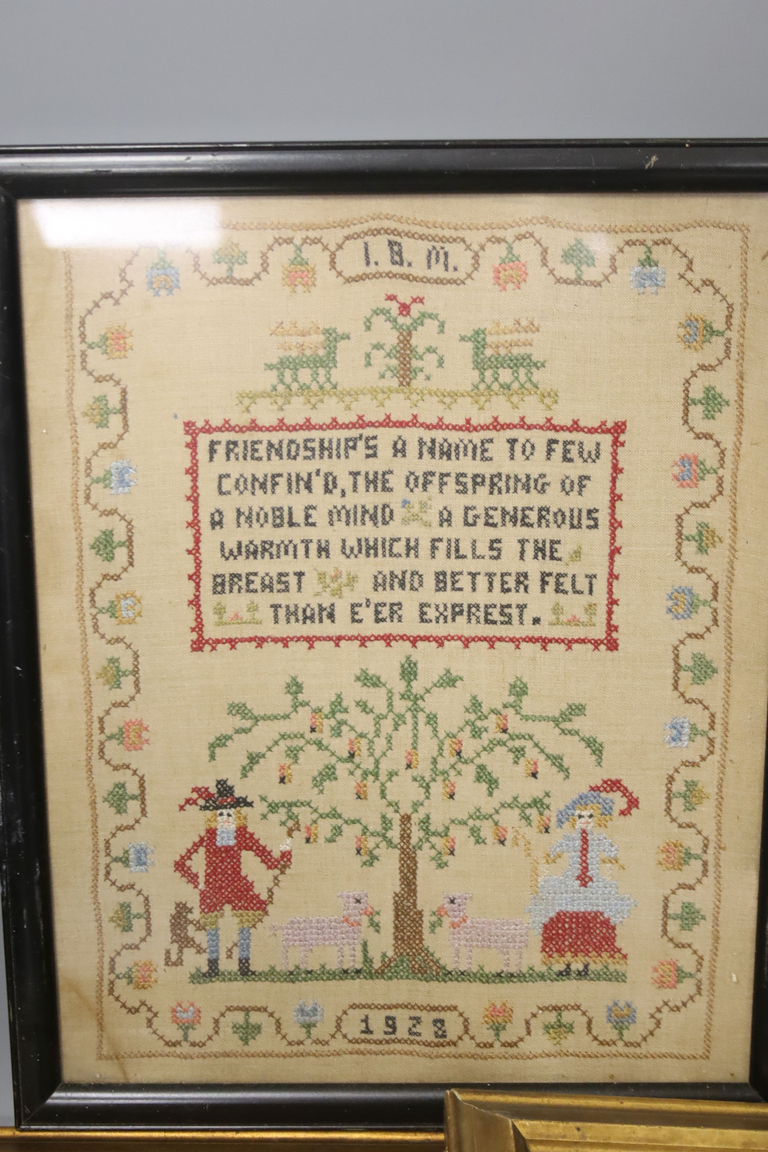 Pair of 19th century petit point face screens, a 1920s sampler and a heraldic panel, all framed.